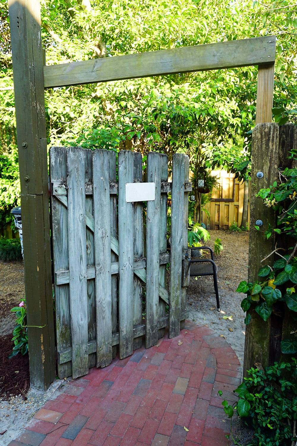 a wooden gate with a sign on it