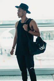 A dynamic shot of a person wearing activewear while traveling through an airport.
