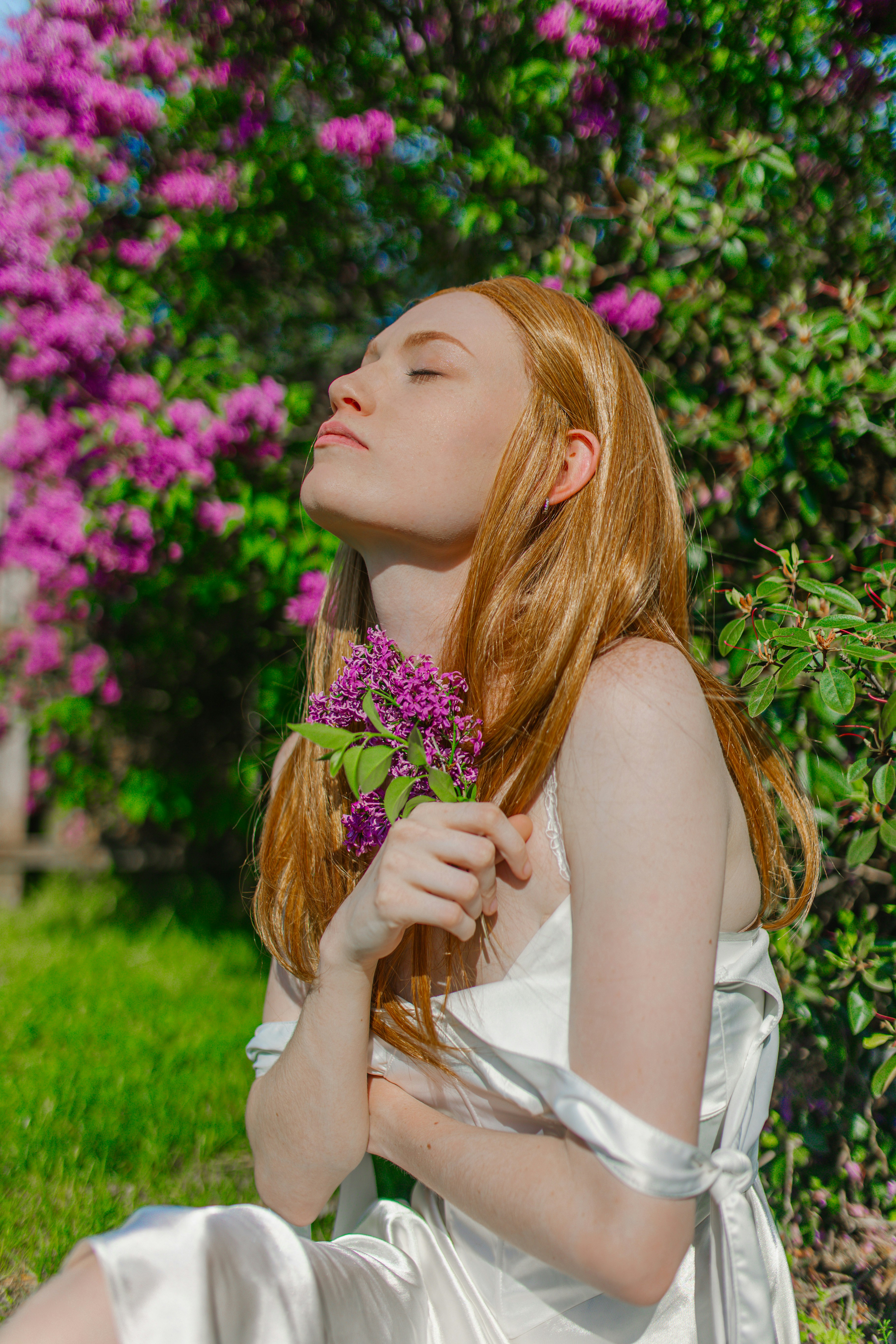 a woman in a white dress holding a flower