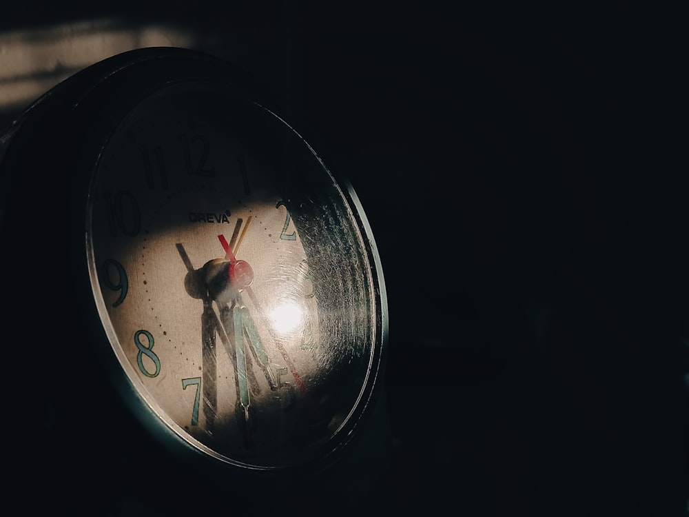 a close up of a clock in the dark