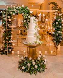 a white wedding cake sitting on top of a table