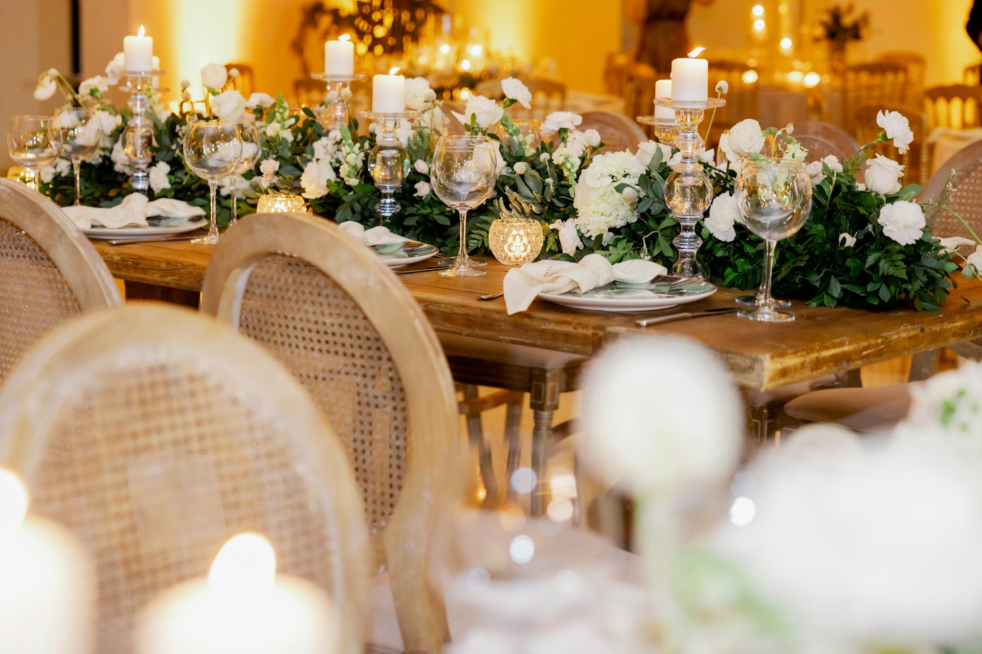 a table set for a formal dinner with candles and flowers