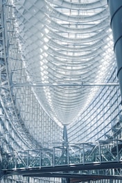 the ceiling of a large building with a clock on it