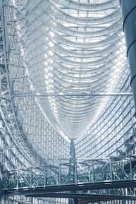 the ceiling of a large building with a clock on it
