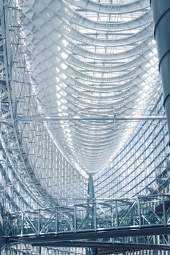 the ceiling of a large building with a clock on it