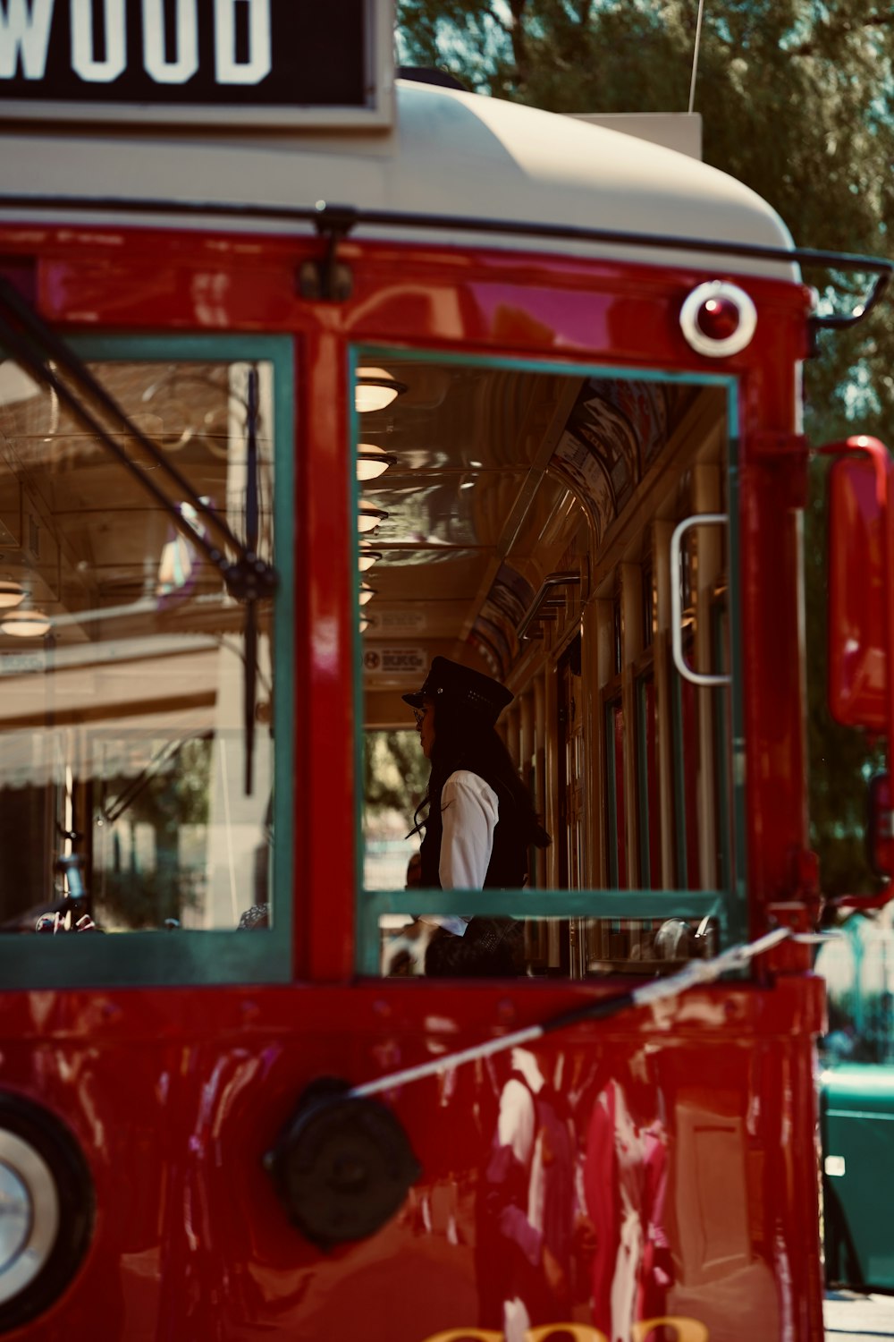 a red and white trolley car on a city street