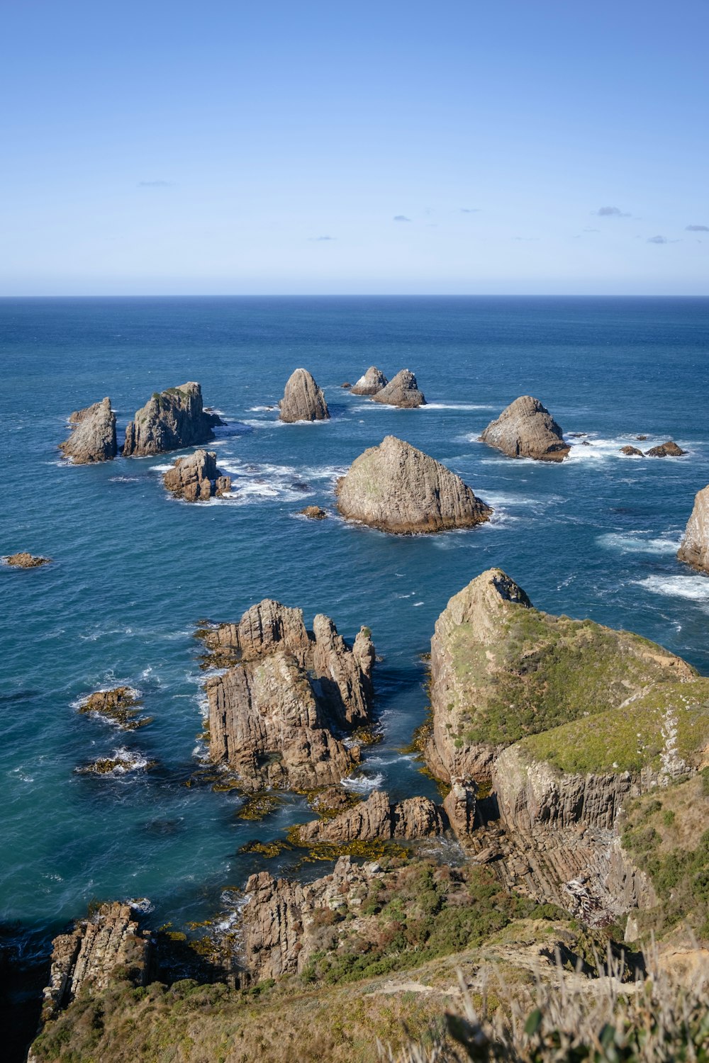 a view of the ocean with rocks in the foreground