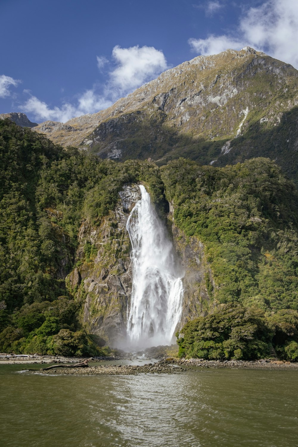 a large waterfall in the middle of a forest