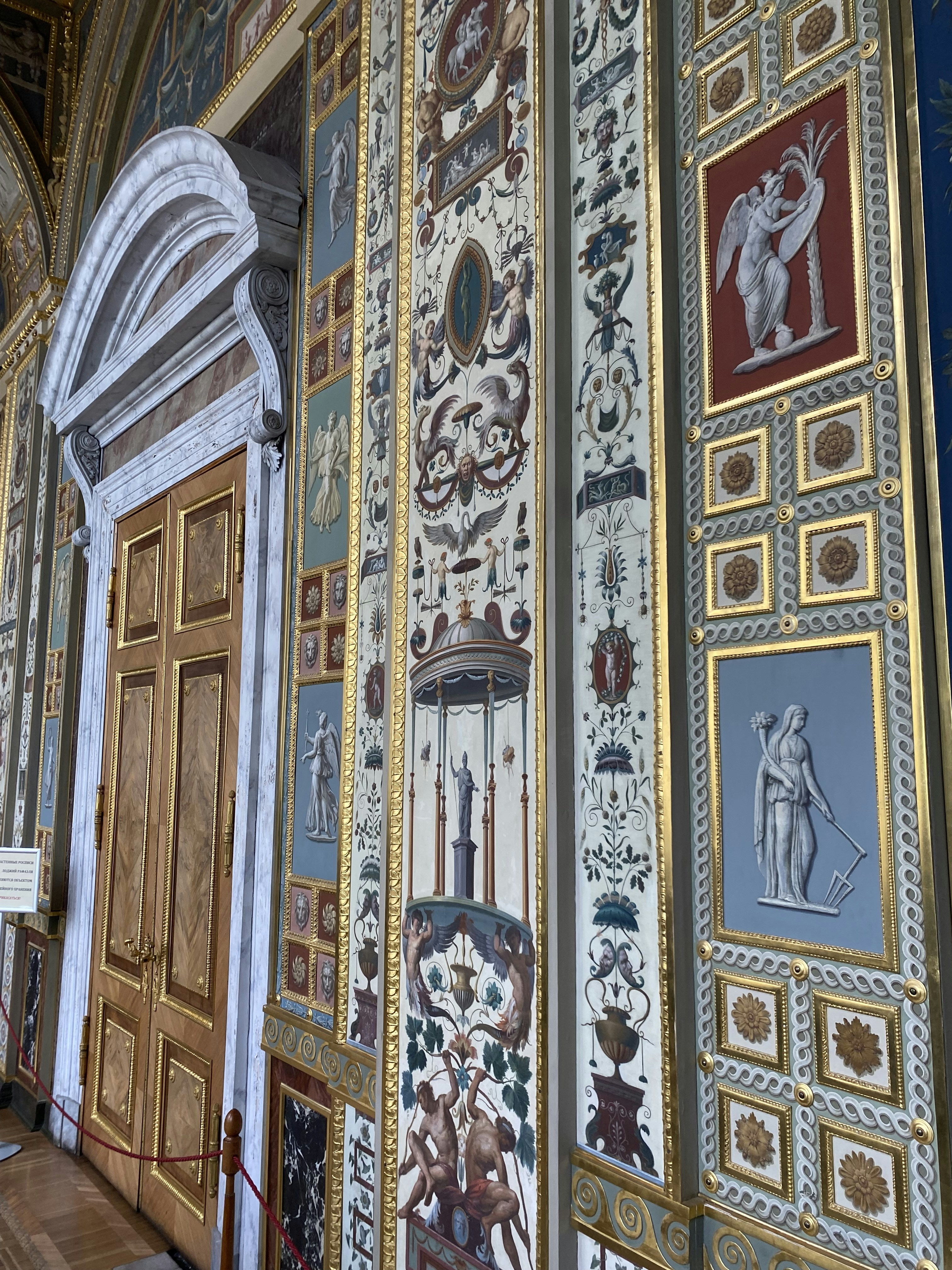 a wall with a bunch of paintings on it