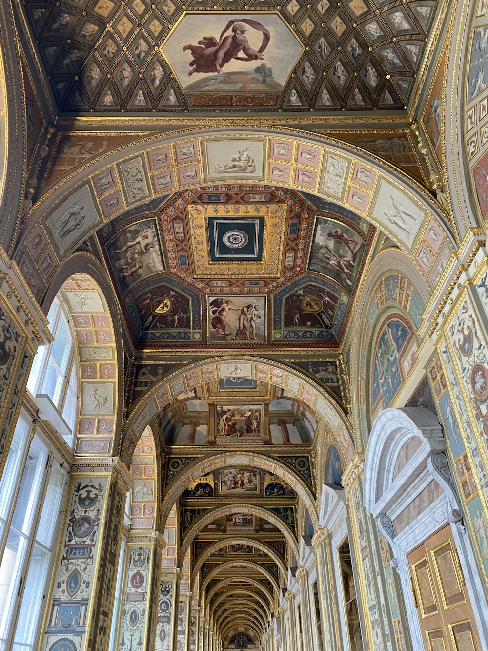 the ceiling of a building with paintings on it