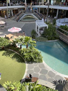 Site overview of a luxury mixed-use development with landscaped gardens and retail spaces.