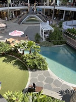 A lively retail corridor featuring contemporary design and natural decor elements.