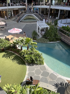 A lively retail corridor featuring contemporary design and natural decor elements.