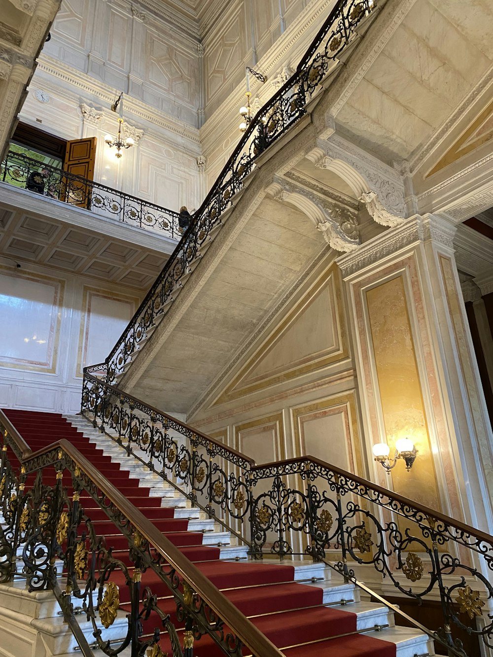 a staircase in a building with a red carpet