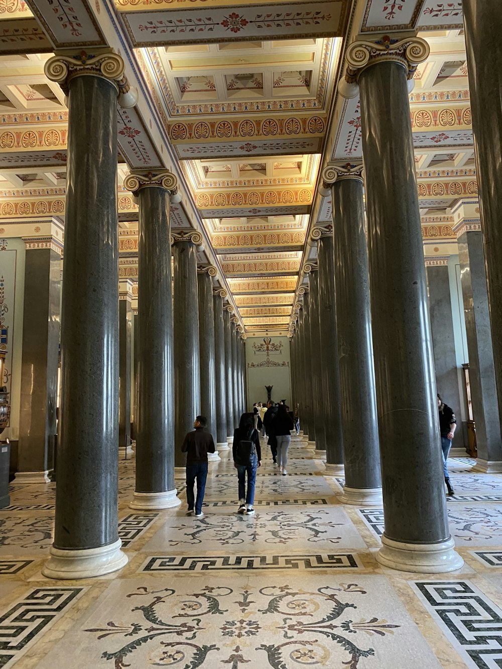 a group of people walking through a large building