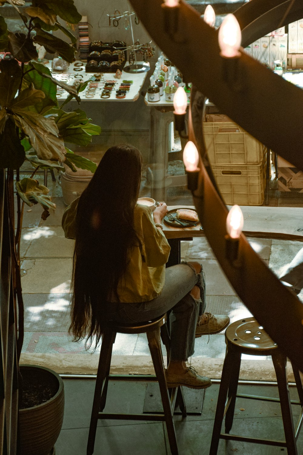 a woman sitting at a table with a plate of food