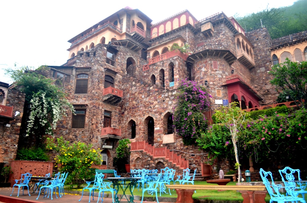 a large building with a bunch of blue chairs in front of it