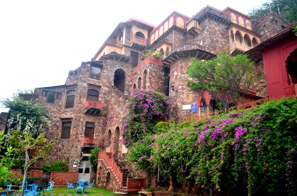 a large building with a bunch of flowers growing on the side of it