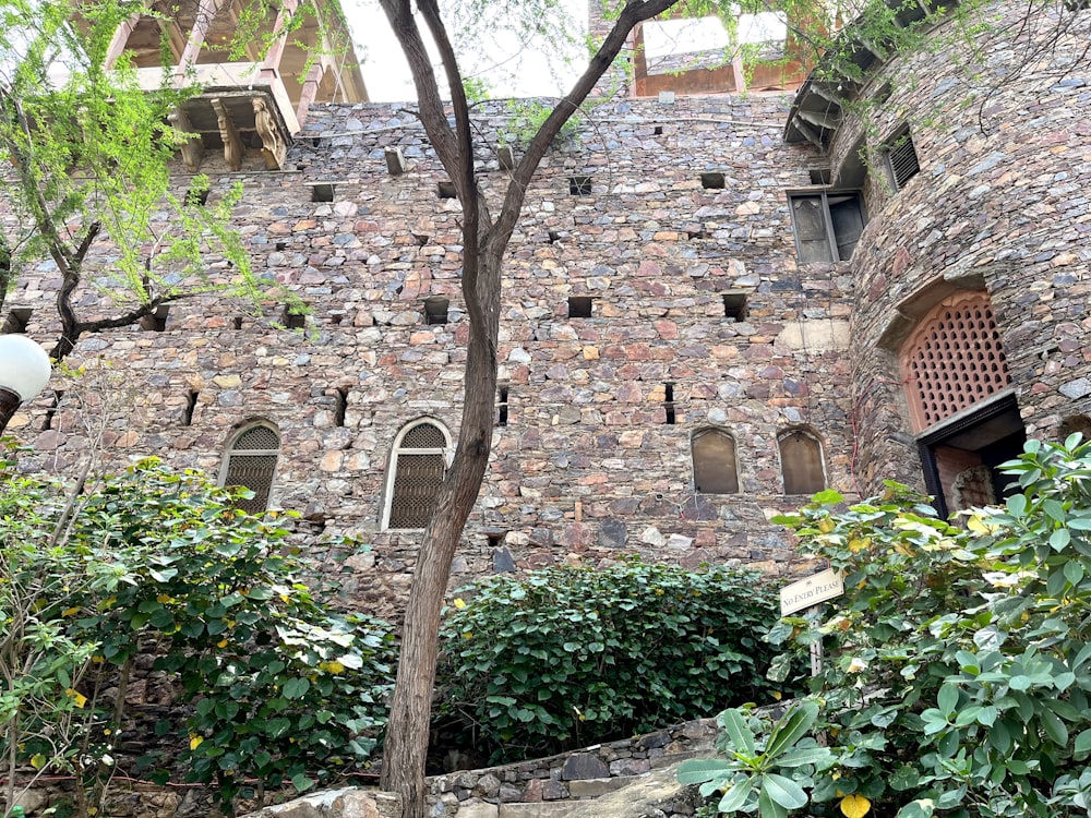 a stone building with a clock on the side of it