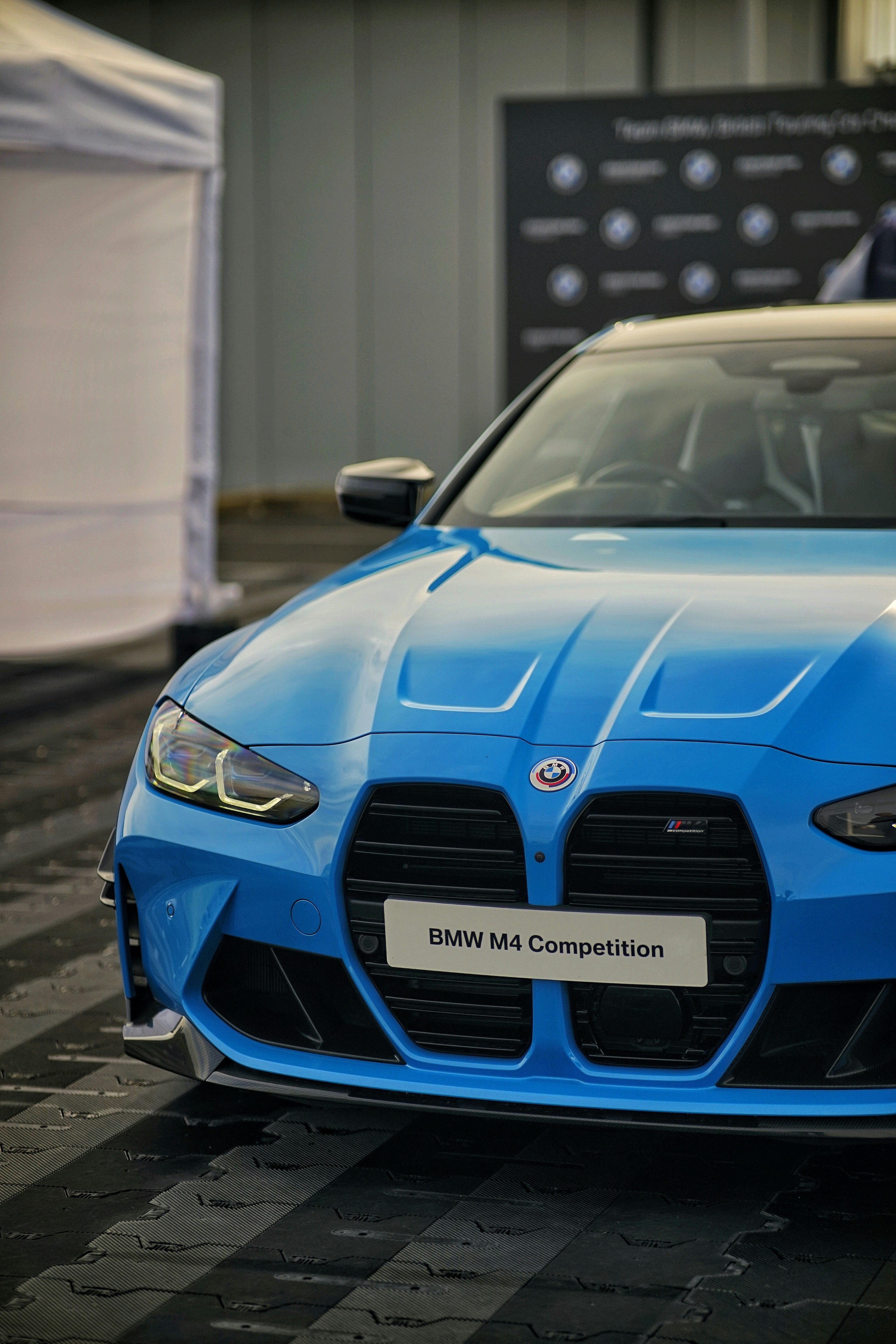 a blue sports car parked in front of a building