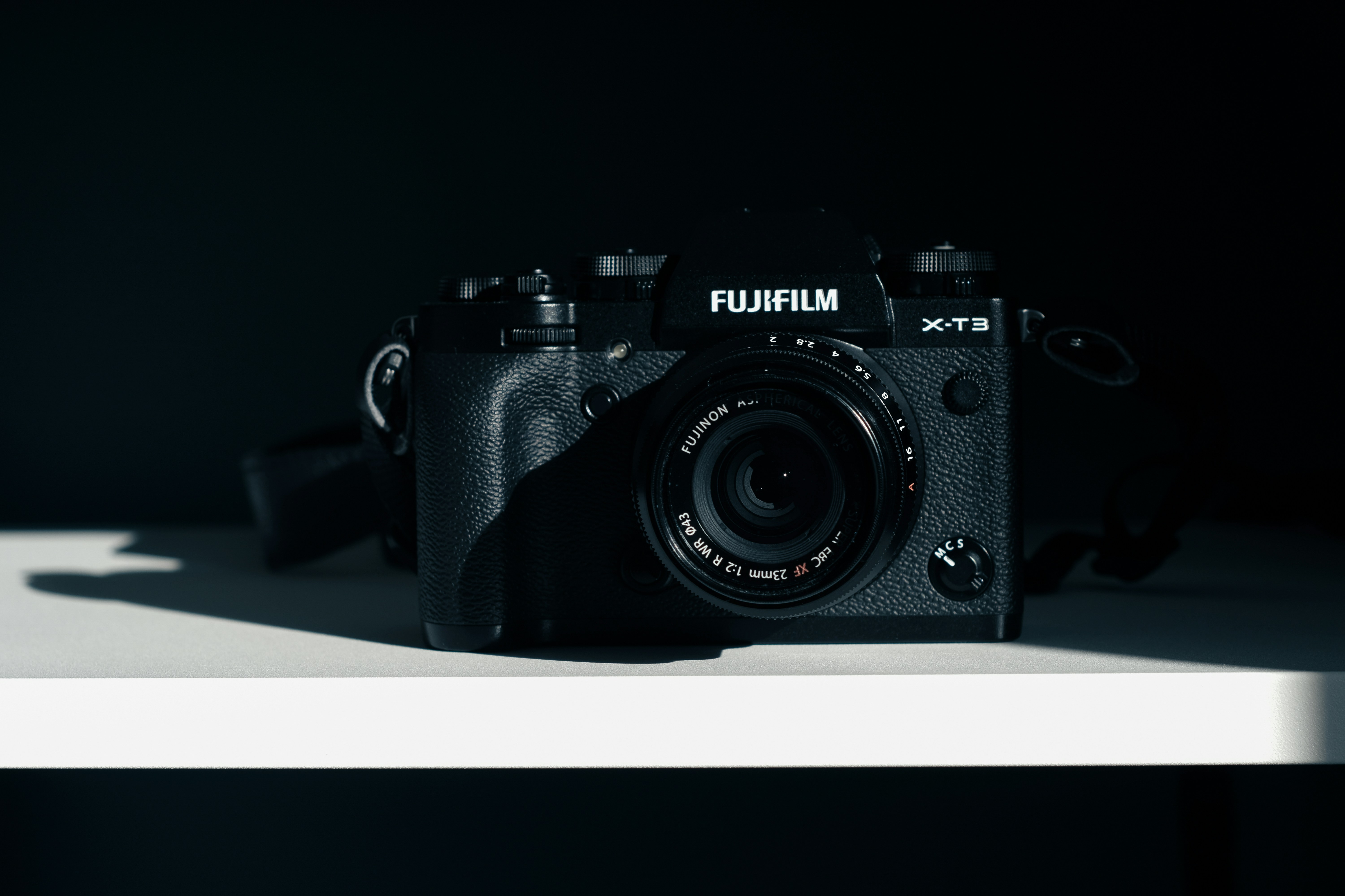 a camera sitting on top of a white shelf