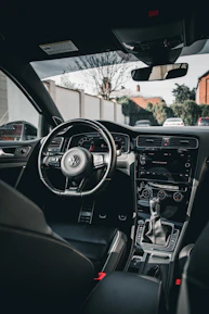 the interior of a car with a steering wheel and dashboard