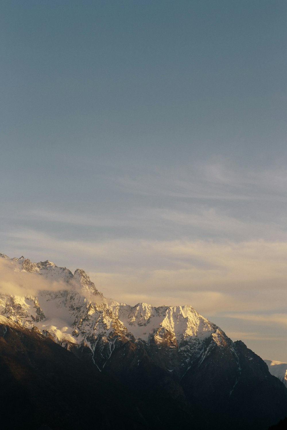 a view of a mountain range with snow on it