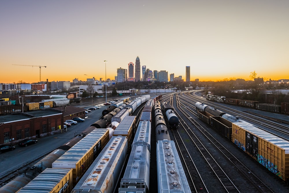 a train yard with several trains on the tracks