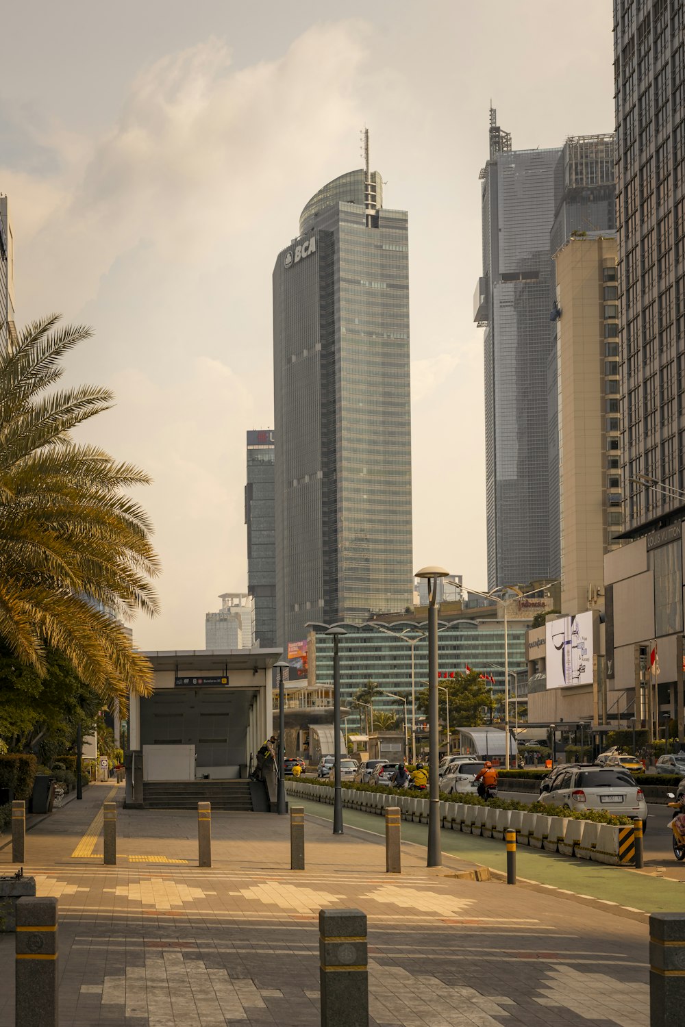 a city street with tall buildings in the background