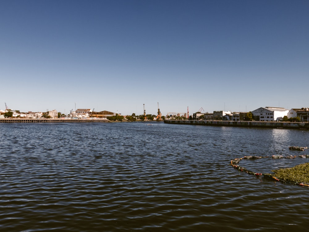 a body of water with houses in the background