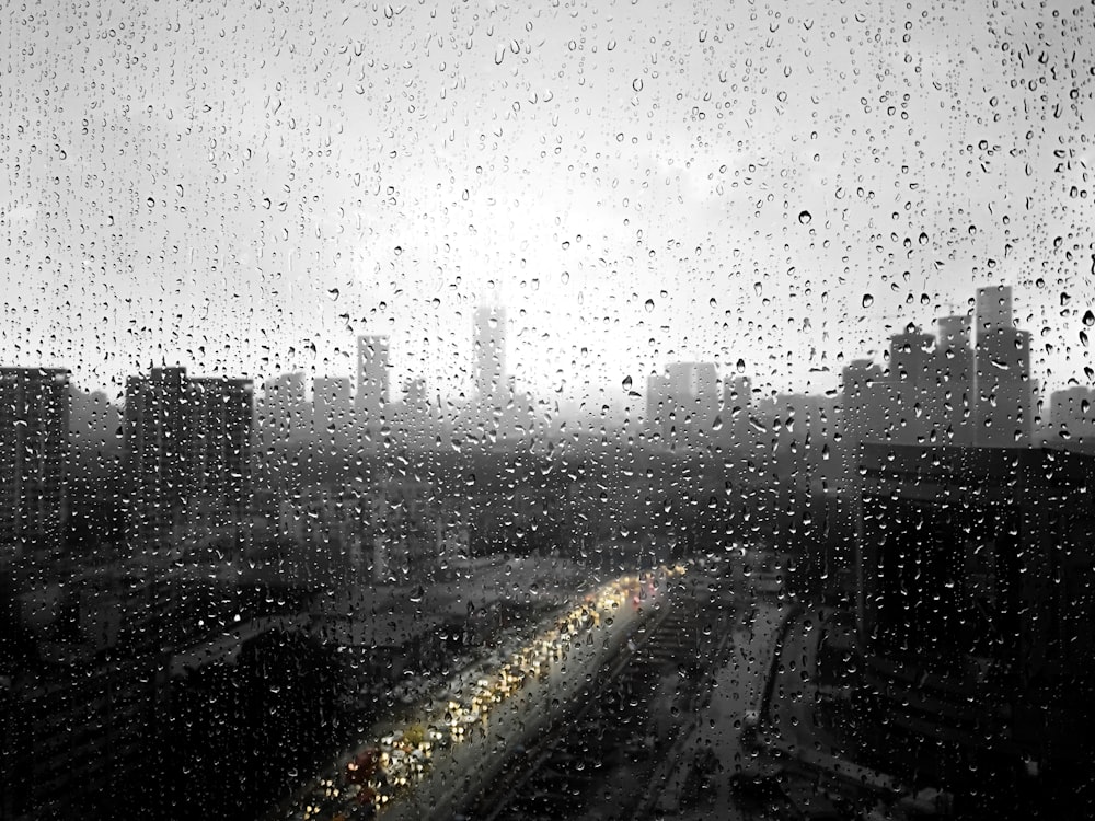 a view of a city through a rain covered window