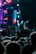 A lively concert crowd with a close-up of a person enjoying music wearing sleek earplugs.