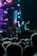 A lively concert crowd enjoying a vibrant music performance under colorful stage lights.