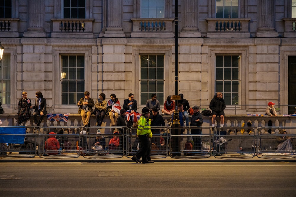 a group of people standing next to each other on a street