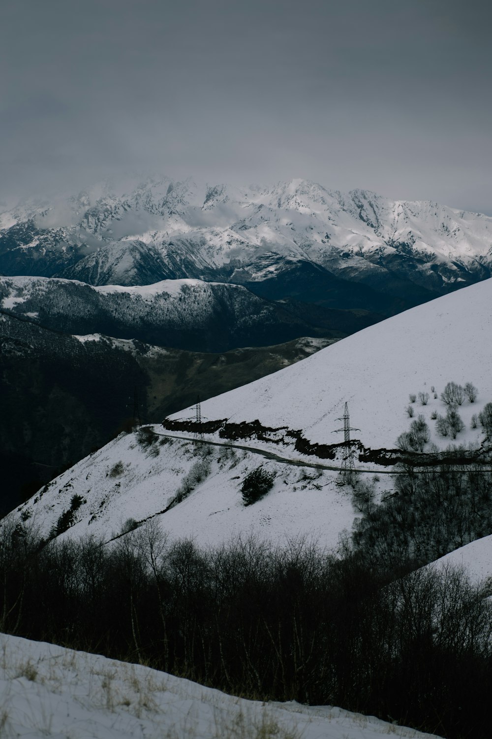 a train traveling down a snow covered mountain side