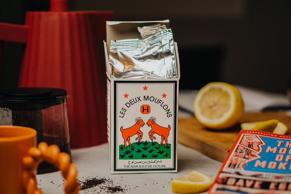 a box of lemonade next to a cup of coffee