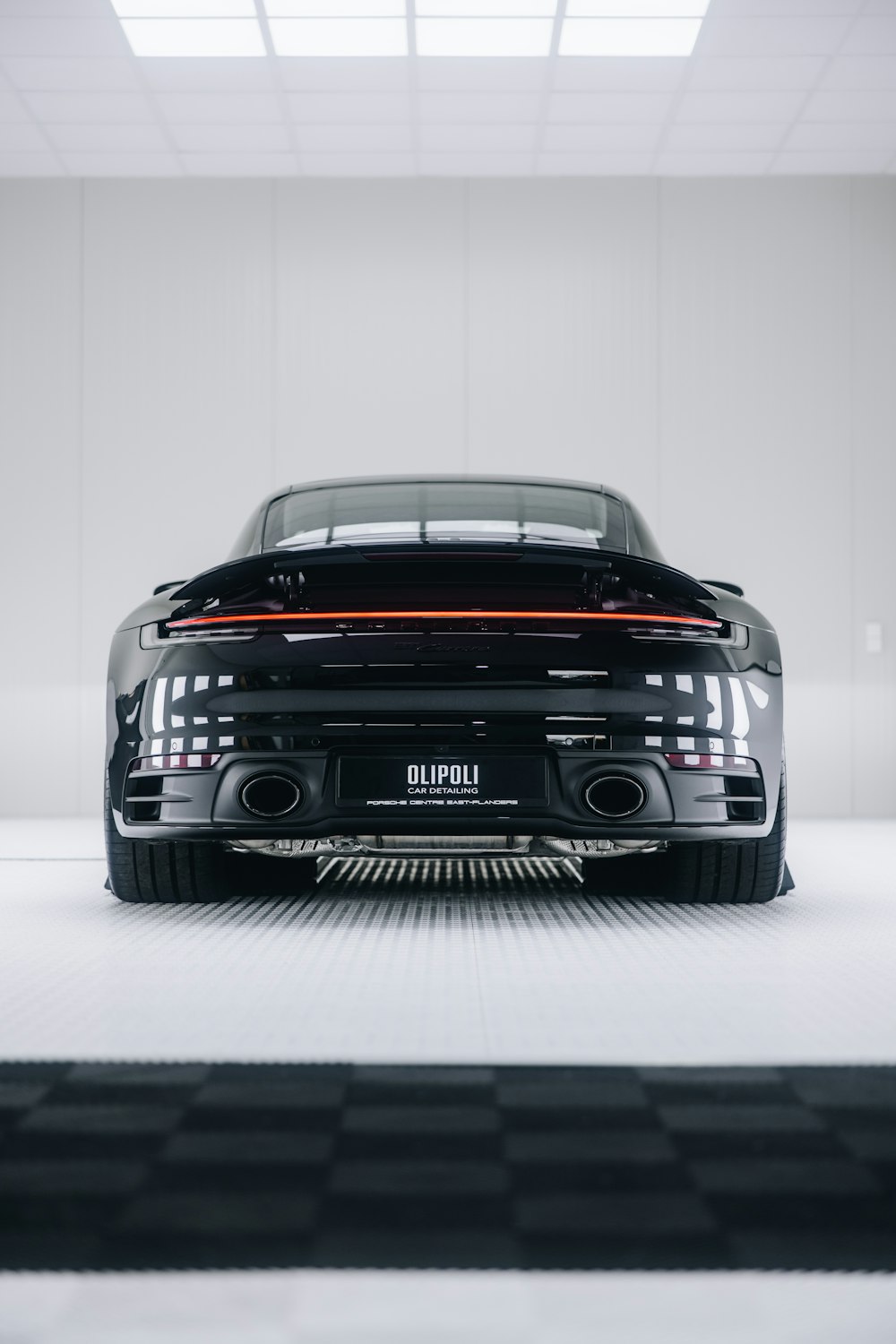 a black sports car parked in a garage