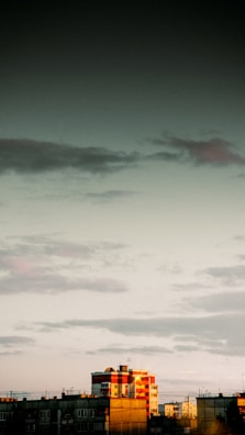 The Capital Insurance Group office building bathed in warm morning light with the West Coast skyline behind it.