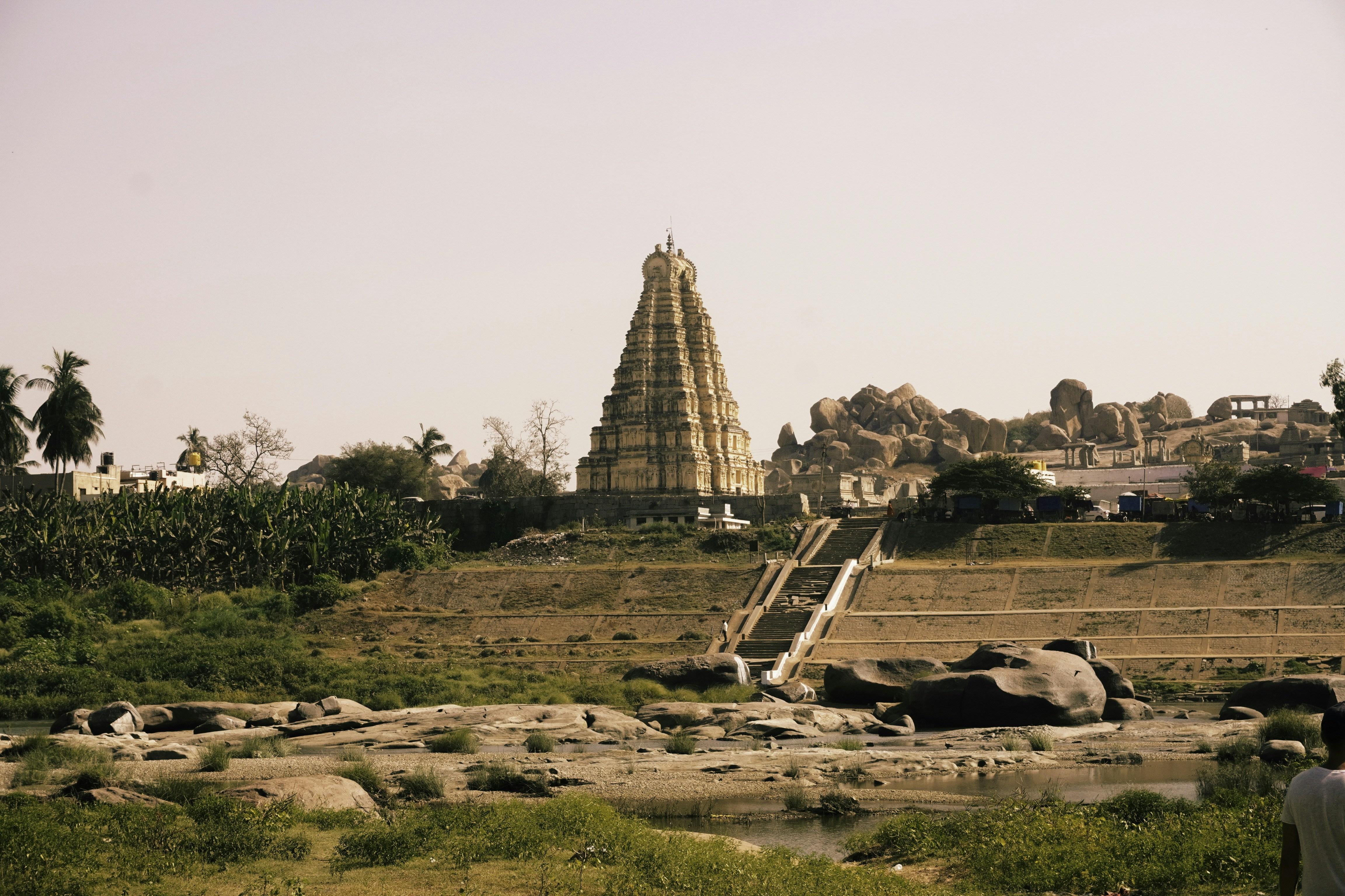 a man standing in front of a very tall building