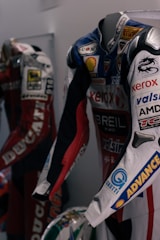 A dynamic image showcasing professional racing suits and gear.