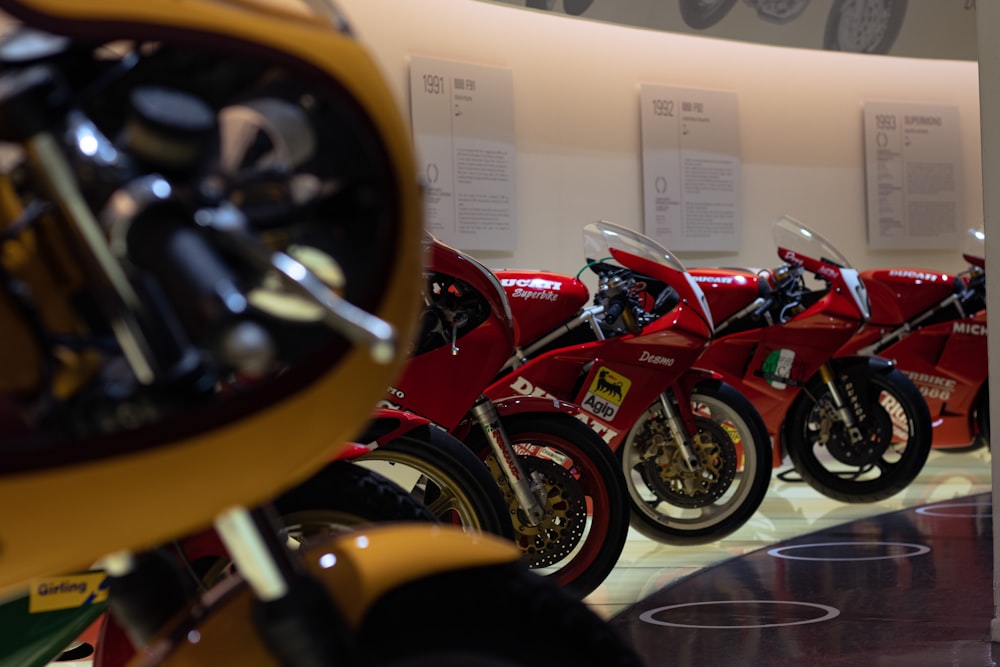 a row of red motorcycles parked next to each other