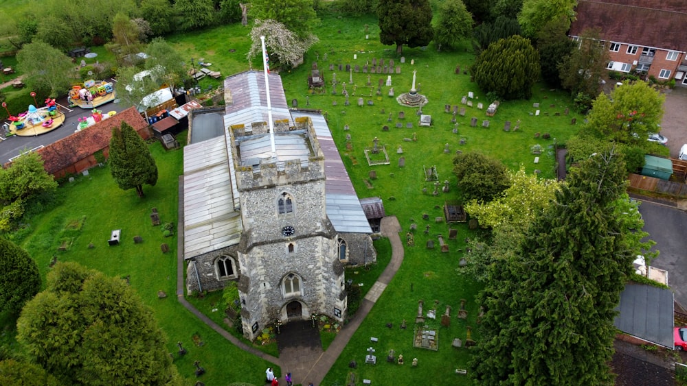 an aerial view of a church surrounded by trees