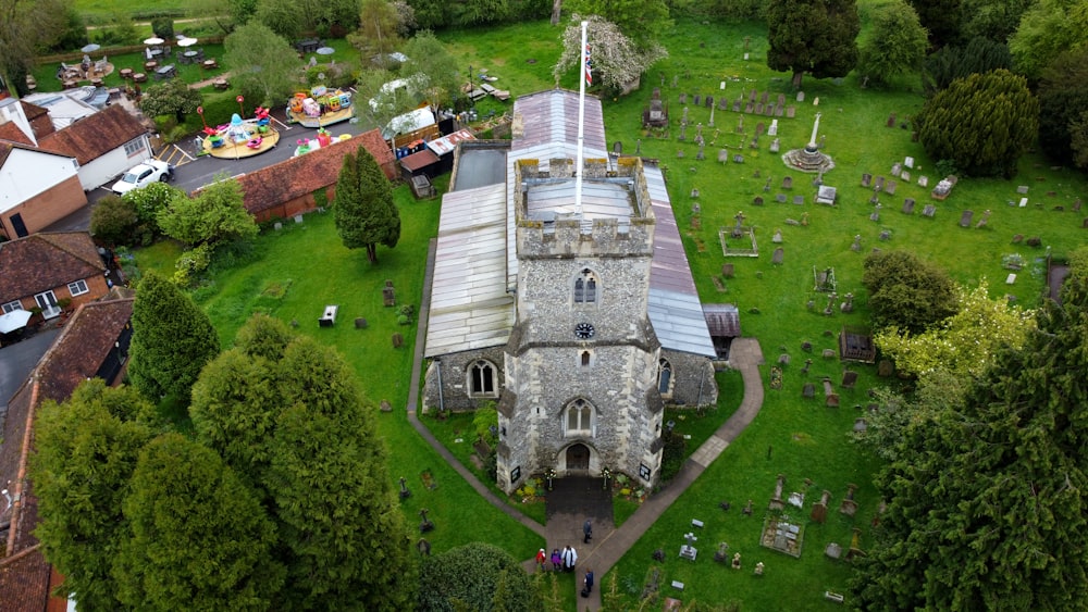 an aerial view of a church surrounded by trees