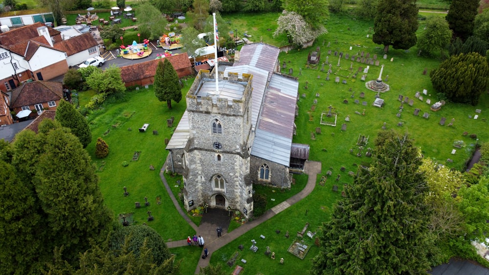 an aerial view of a church surrounded by trees