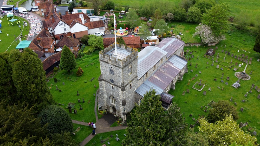 an aerial view of a church with a cemetery in the foreground