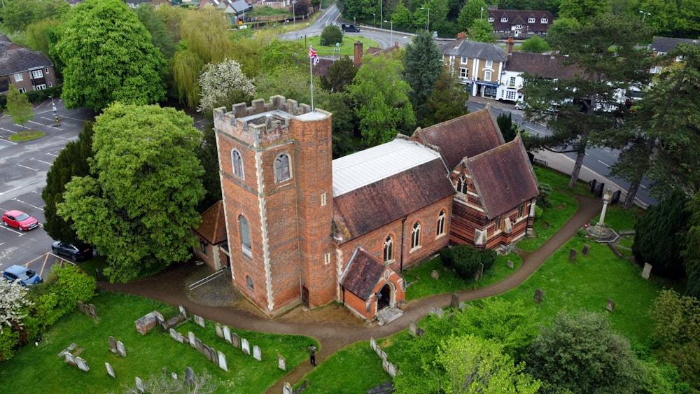 an aerial view of an old church in a cemetery