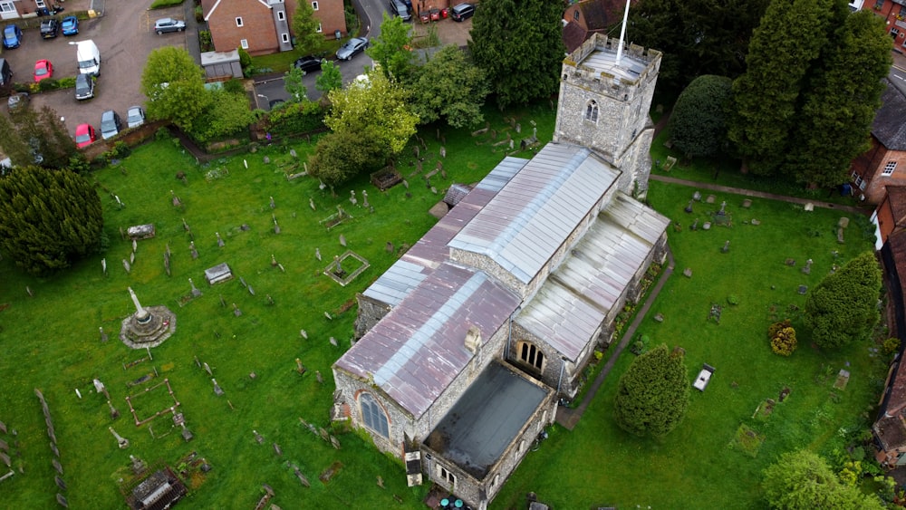 an aerial view of a church in a cemetery