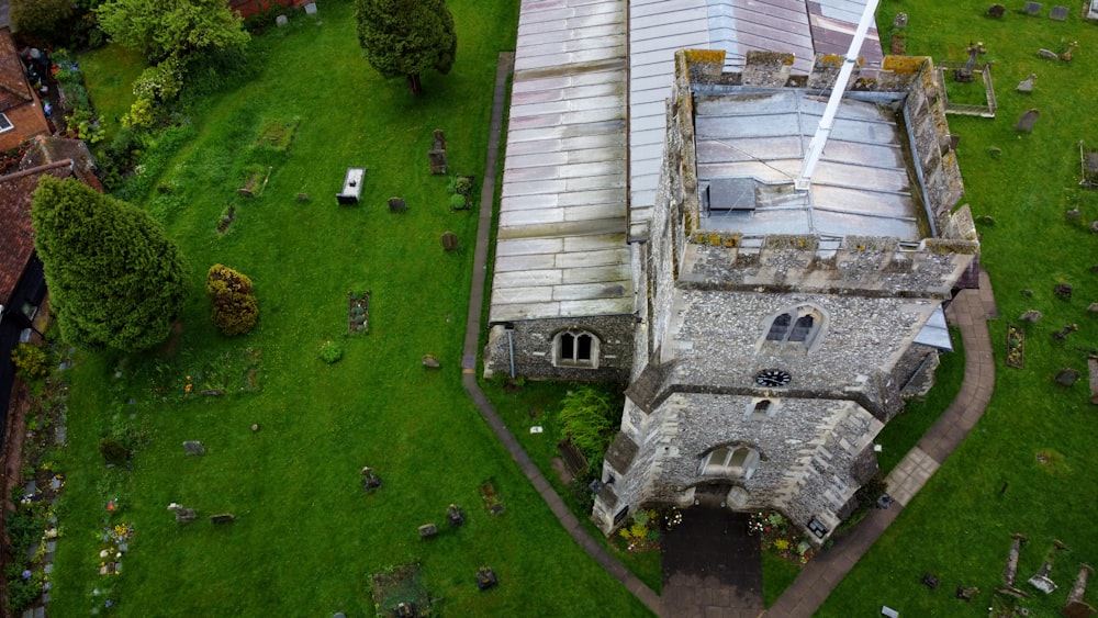 an aerial view of an old church in a cemetery