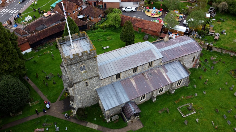 an aerial view of an old building with a flag on top of it