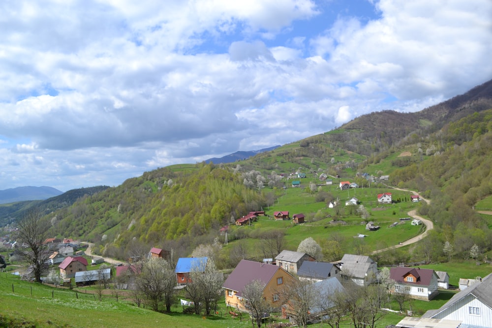 a small village in the middle of a green valley